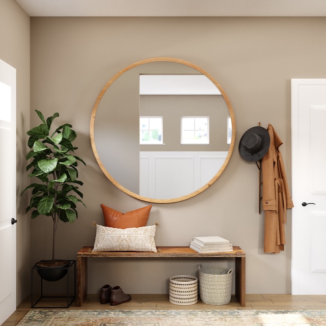 Brown wooden framed mirror on a white wall